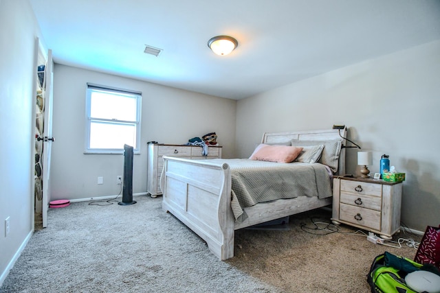 bedroom with baseboards, visible vents, and light colored carpet