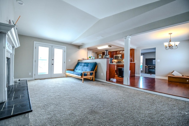 interior space with baseboards, an inviting chandelier, vaulted ceiling, french doors, and dark carpet