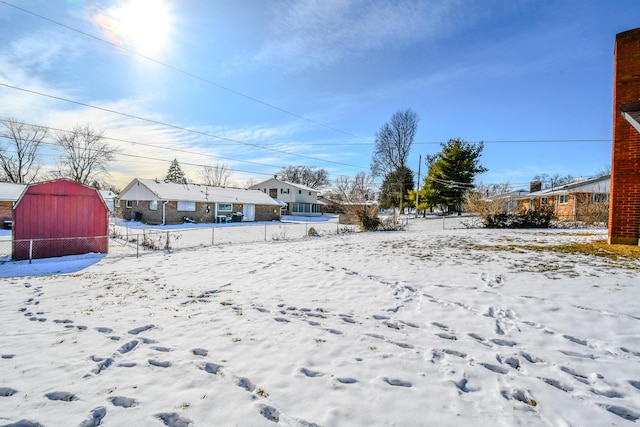 snowy yard with fence