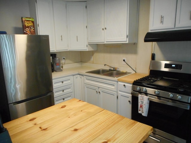 kitchen featuring appliances with stainless steel finishes, sink, and exhaust hood