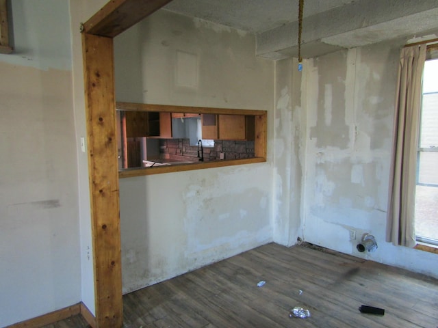 spare room featuring a sink and wood finished floors