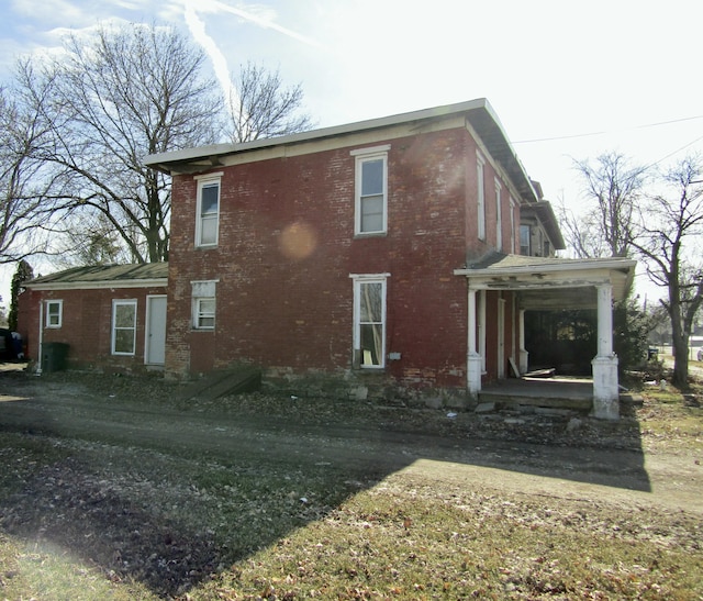 view of property exterior with brick siding