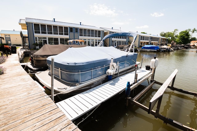 view of dock featuring a water view and boat lift