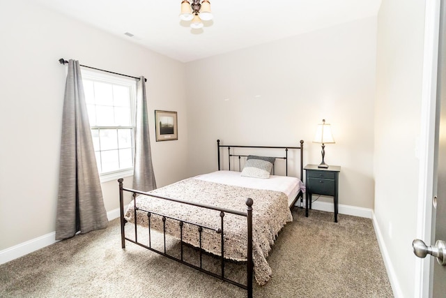 bedroom with carpet flooring and baseboards