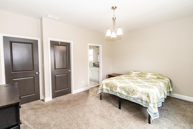 carpeted bedroom with baseboards, ensuite bath, visible vents, and an inviting chandelier