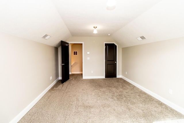bonus room featuring carpet floors, baseboards, lofted ceiling, and visible vents