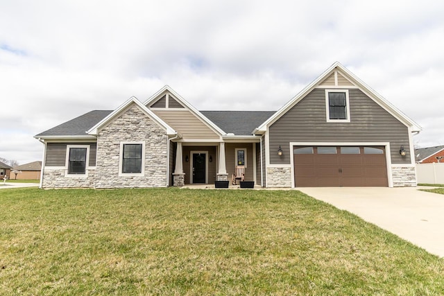 craftsman-style home featuring stone siding, an attached garage, concrete driveway, a front yard, and roof with shingles