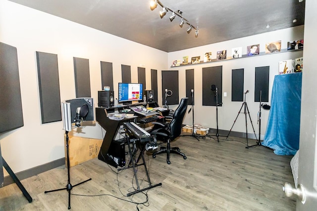 office area featuring baseboards, wood finished floors, and track lighting
