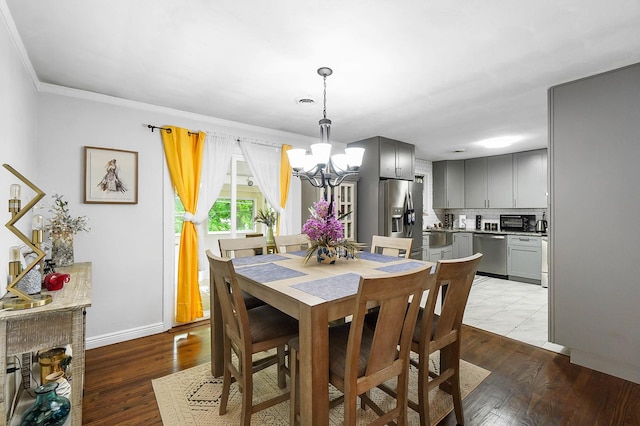 1306 Kercher St, Miamisburg, OH 45342 - dining space featuring a chandelier, wood finished floors, baseboards, and ornamental molding