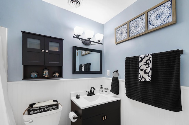 1306 Kercher St, Miamisburg, OH 45342 - half bath featuring vanity, a wainscoted wall, and toilet