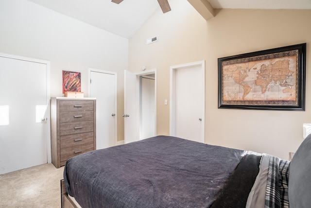 bedroom featuring visible vents, beam ceiling, high vaulted ceiling, a ceiling fan, and carpet flooring