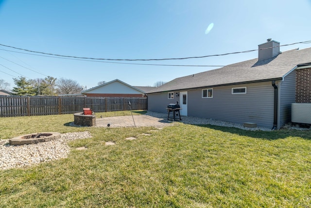 view of yard with a patio area, a fenced backyard, and an outdoor fire pit