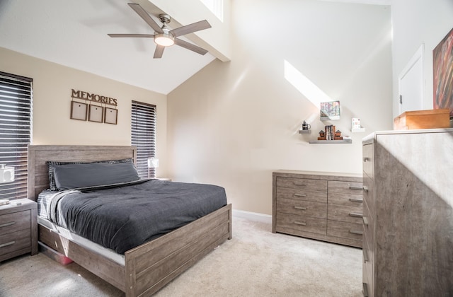 bedroom featuring baseboards, light colored carpet, beam ceiling, high vaulted ceiling, and a ceiling fan