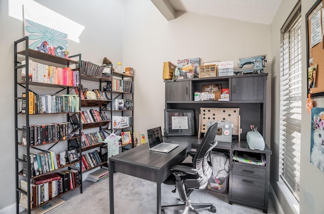 carpeted office featuring lofted ceiling with beams and a textured ceiling