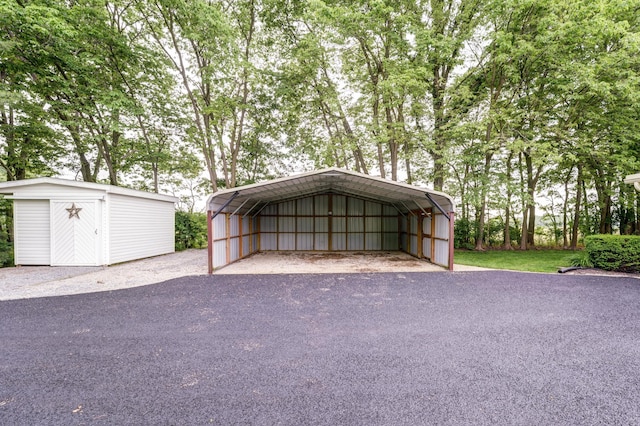 5341 Riffle Rd, Ansonia, OH 45303 - garage with a detached carport, a storage shed, and driveway