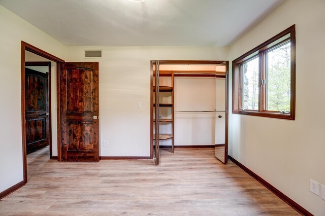 5341 Riffle Rd, Ansonia, OH 45303 - unfurnished bedroom featuring light wood-style flooring, baseboards, and a closet