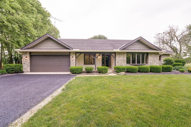 5341 Riffle Rd, Ansonia, OH 45303 - view of front of property with stone siding, an attached garage, and asphalt driveway