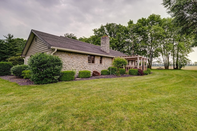 5341 Riffle Rd, Ansonia, OH 45303 - view of home's exterior with a chimney, stone siding, and a lawn