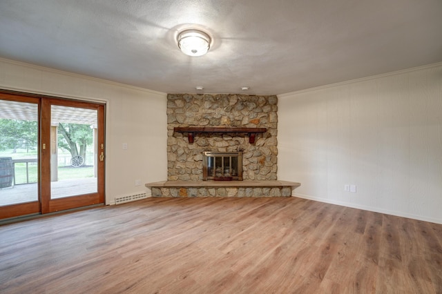 5341 Riffle Rd, Ansonia, OH 45303 - unfurnished living room featuring crown molding, a stone fireplace, wood finished floors, and baseboards