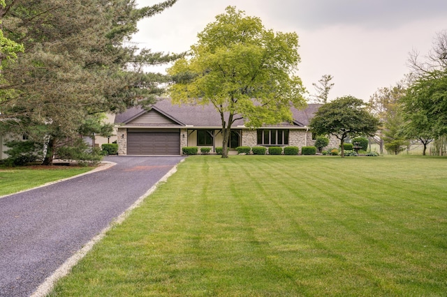 5341 Riffle Rd, Ansonia, OH 45303 - single story home with asphalt driveway, a garage, a front yard, and stone siding