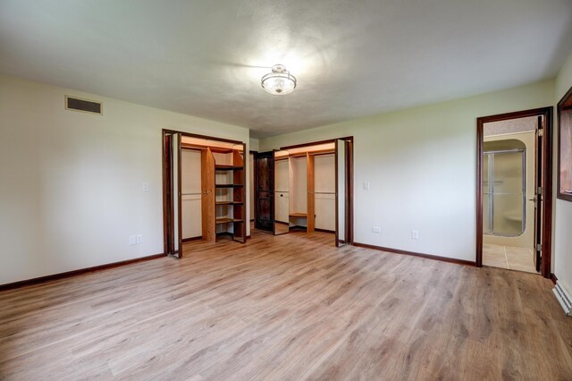 5341 Riffle Rd, Ansonia, OH 45303 - unfurnished bedroom featuring baseboards, light wood-type flooring, and connected bathroom