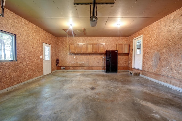 5341 Riffle Rd, Ansonia, OH 45303 - garage featuring black fridge and a garage door opener