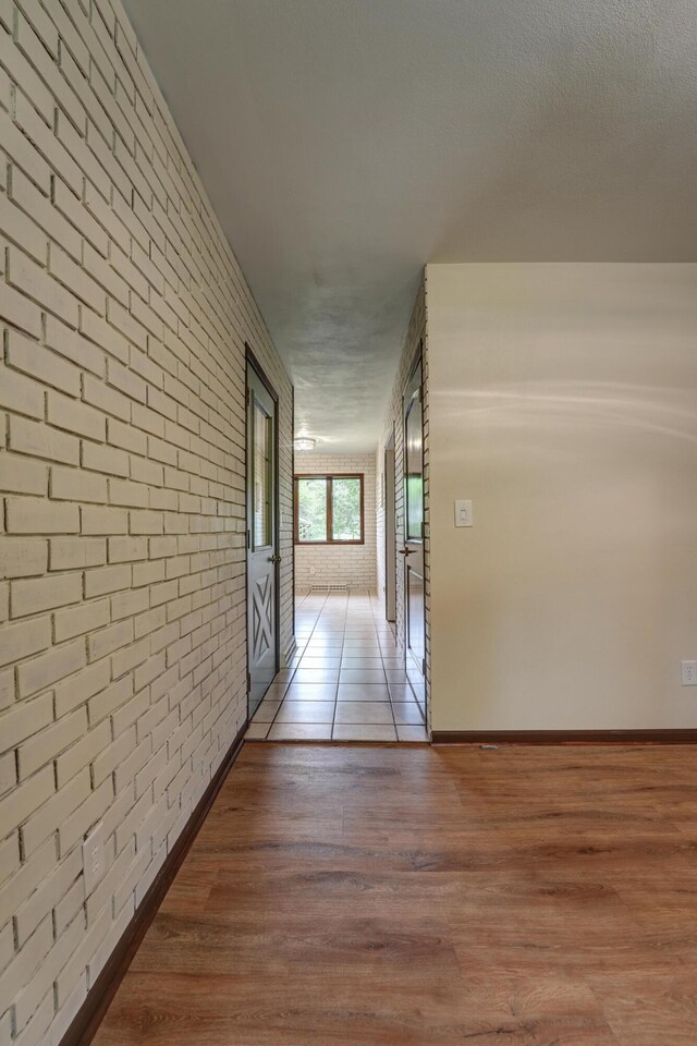 5341 Riffle Rd, Ansonia, OH 45303 - hallway with brick wall, wood finished floors, and baseboards