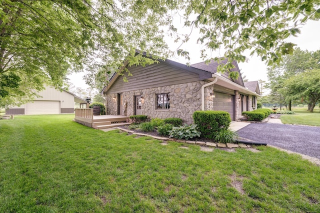 5341 Riffle Rd, Ansonia, OH 45303 - view of property exterior featuring stone siding, a lawn, a wooden deck, driveway, and a garage