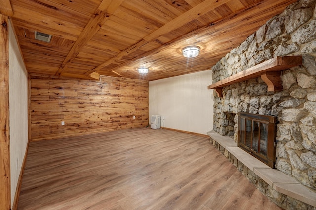 5341 Riffle Rd, Ansonia, OH 45303 - unfurnished living room with wooden ceiling, wood finished floors, a stone fireplace, baseboards, and wooden walls