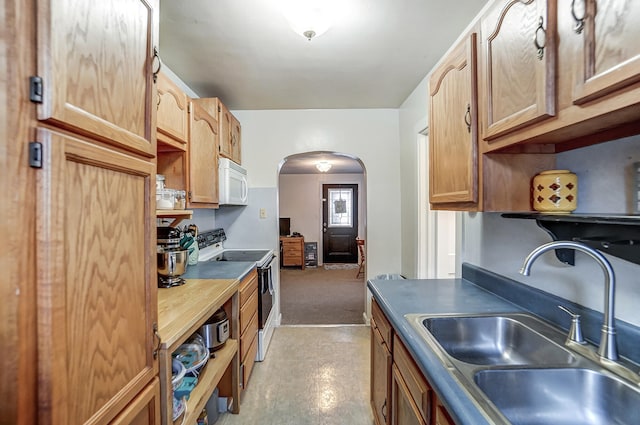 kitchen featuring white appliances and sink