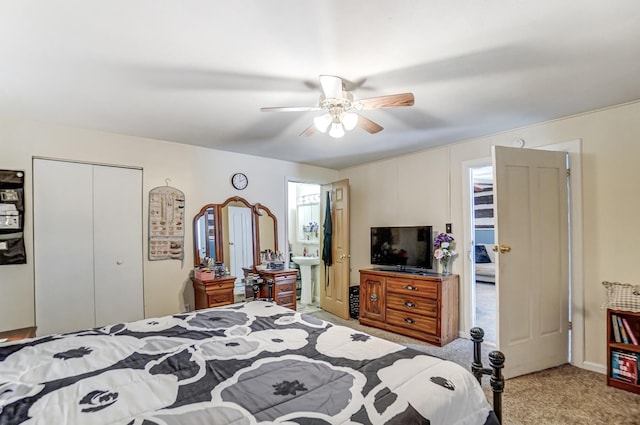 bedroom with sink, light carpet, ceiling fan, and a closet