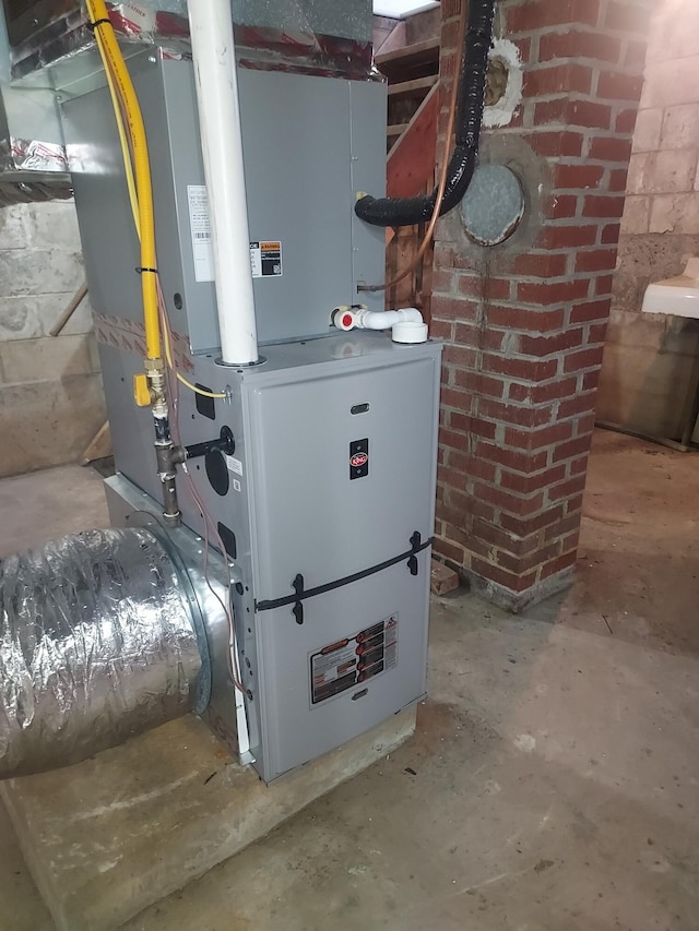 utility room featuring heating unit