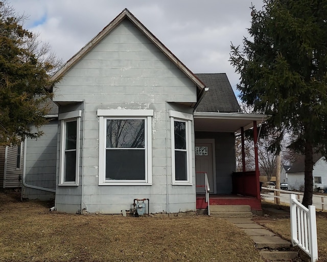 view of front of property featuring covered porch and roof with shingles