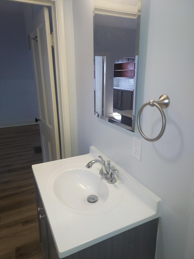 bathroom featuring vanity and wood finished floors