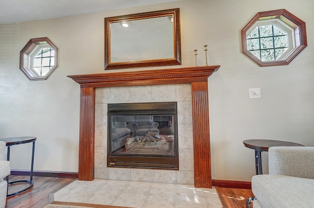 room details featuring a textured ceiling, a fireplace, and baseboards