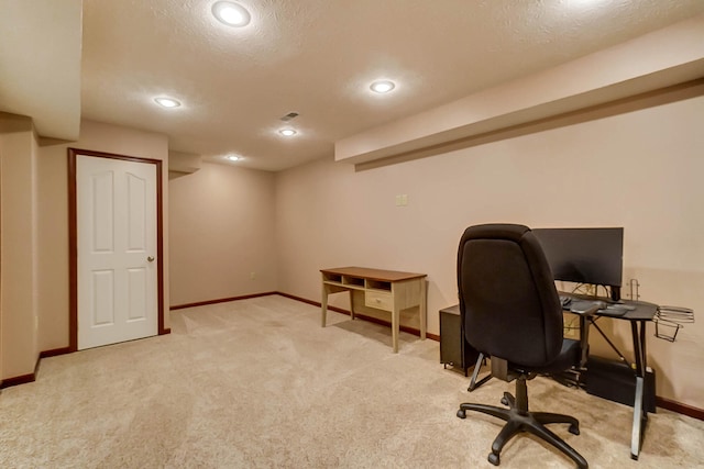 office with light carpet, baseboards, and a textured ceiling