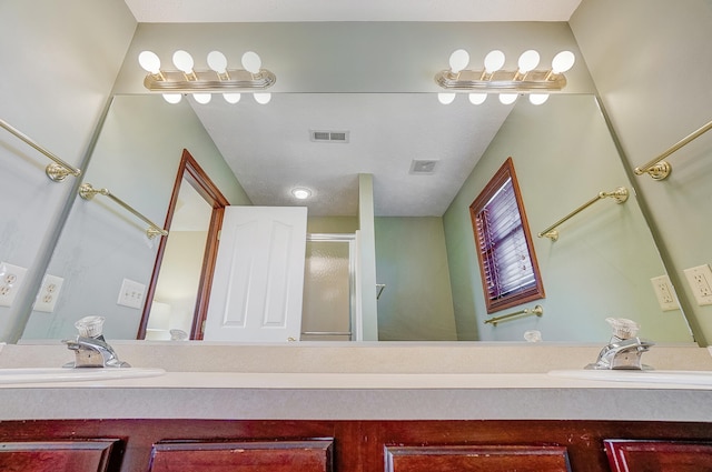 bathroom featuring a shower stall, visible vents, and a sink