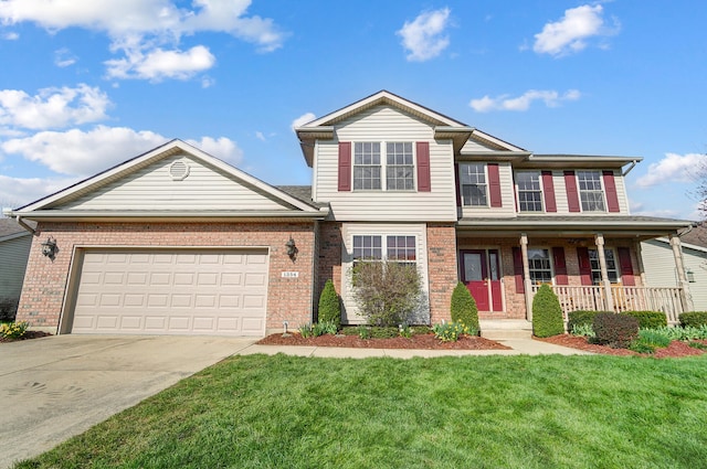 view of front of home featuring a front yard, brick siding, driveway, and covered porch