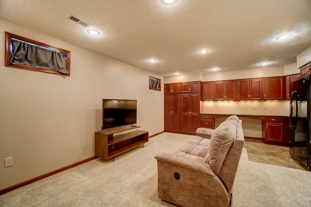 living room featuring visible vents, baseboards, recessed lighting, and light colored carpet