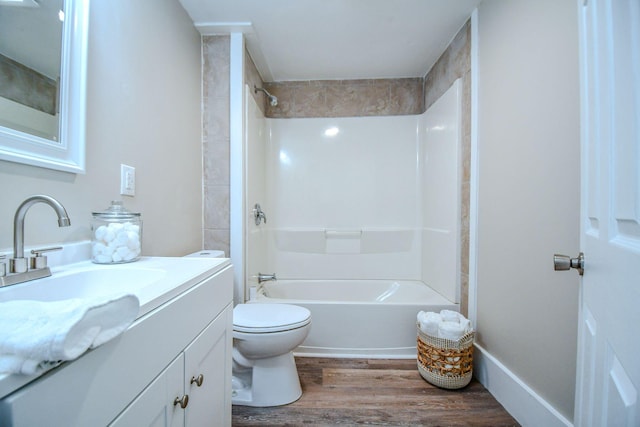 full bathroom featuring vanity,  shower combination, toilet, and hardwood / wood-style flooring