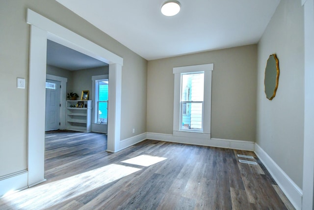 unfurnished room featuring dark hardwood / wood-style floors