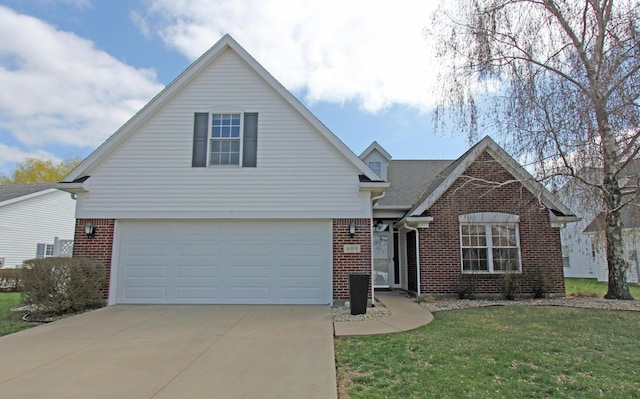 609 Lambert Dr, Piqua, OH 45356 - traditional-style home featuring driveway, a front yard, a garage, and brick siding