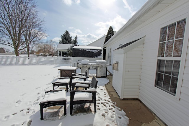 yard covered in snow with fence