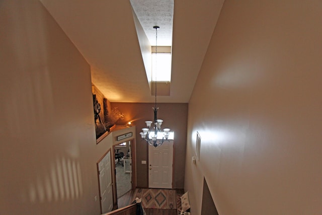 entryway featuring wood finished floors and a notable chandelier