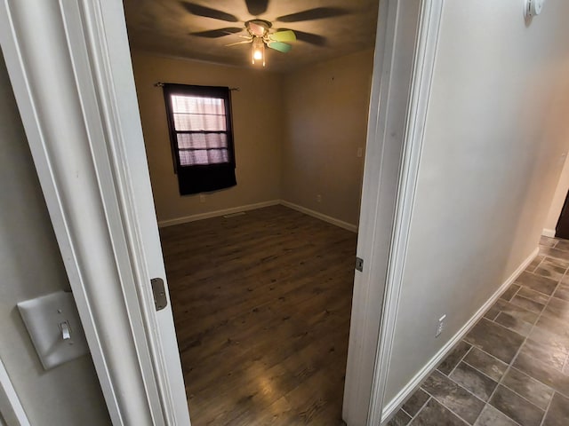 interior space with ceiling fan