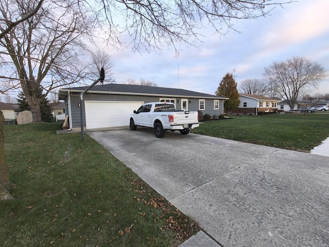 ranch-style home with a garage and a front lawn