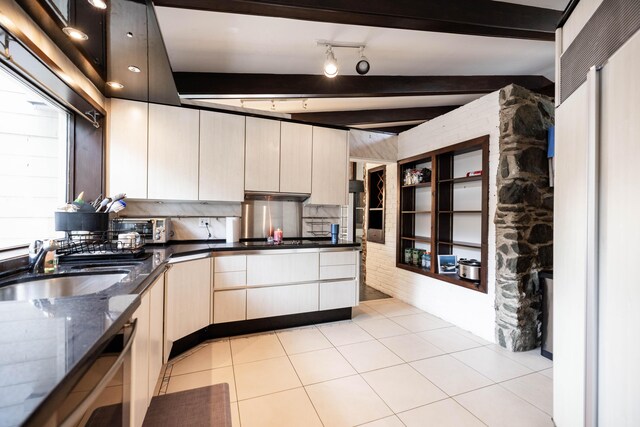 125 Hawthorne Rd, Springfield, OH 45504 - kitchen with dark stone countertops, under cabinet range hood, black stovetop, modern cabinets, and beamed ceiling