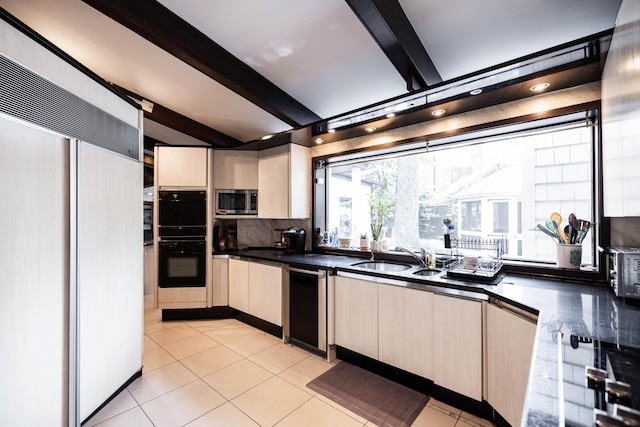 125 Hawthorne Rd, Springfield, OH 45504 - kitchen featuring paneled built in refrigerator, beam ceiling, stainless steel microwave, light brown cabinetry, and dark countertops