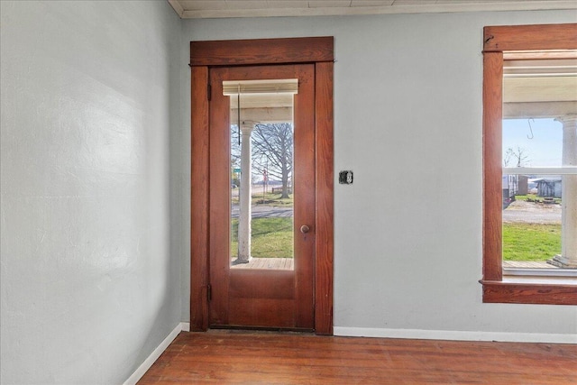 entryway with baseboards and wood finished floors