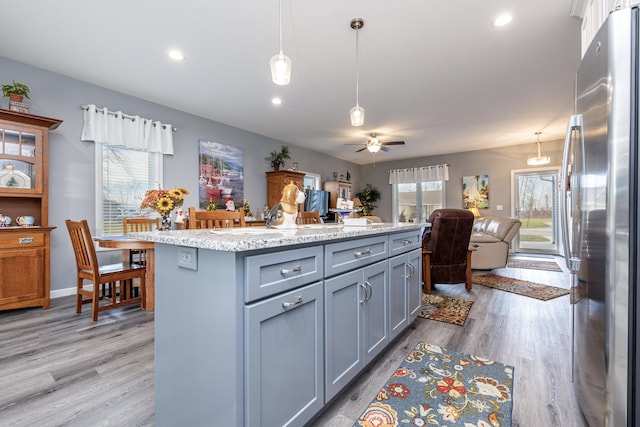 255 N Pine St, Lakeview, OH 43331 - kitchen with freestanding refrigerator, gray cabinets, open floor plan, pendant lighting, and recessed lighting